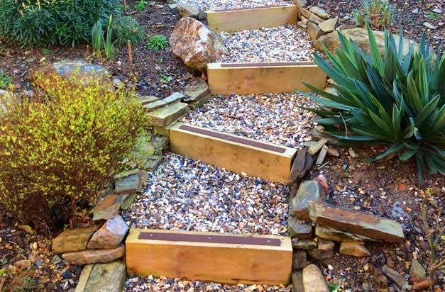 Beautiful garden sleeper steps with decking strips. Landscape design with safety in mind. Beautiful garden sleeper steps with decking strips. Landscape design with safety in mind.