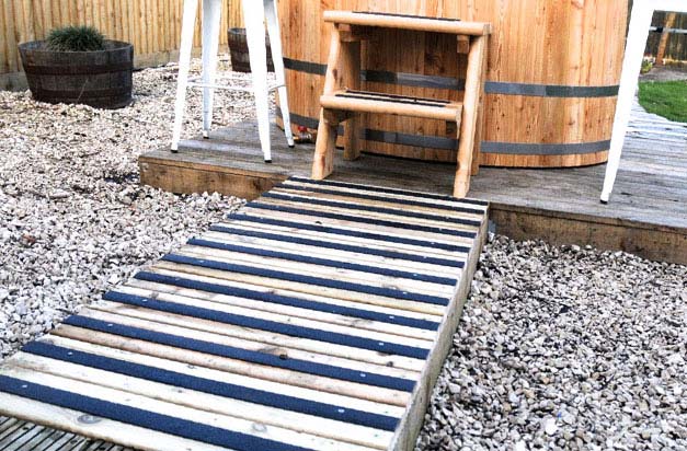 Garden hot tub with anti-slip decking strip path. Garden hot tub with anti-slip decking strip path.