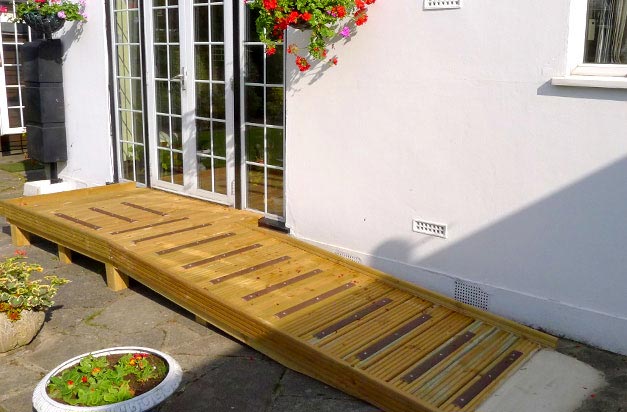 Wooden ramp access platform with non-slip decking strip areas. Wooden ramp access platform with non-slip decking strip areas.