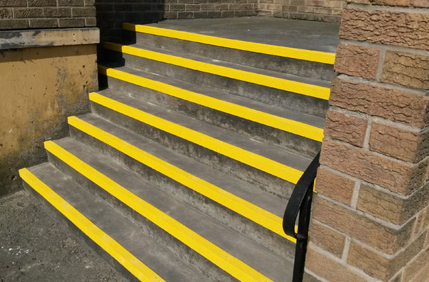 Stairwell entrance steps with DDA compliant yellow stair nosing. Stairwell entrance steps with DDA compliant yellow stair nosing.
