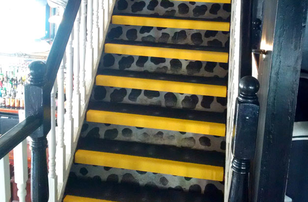 Anti-slip stair tread covers on an interior staircase. Anti-slip stair tread covers on an interior staircase.