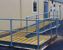 Access ramp with anti-slip decking strips for safety. Access ramp with anti-slip decking strips for safety.